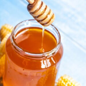 jar of wildflower honey on rustic table
