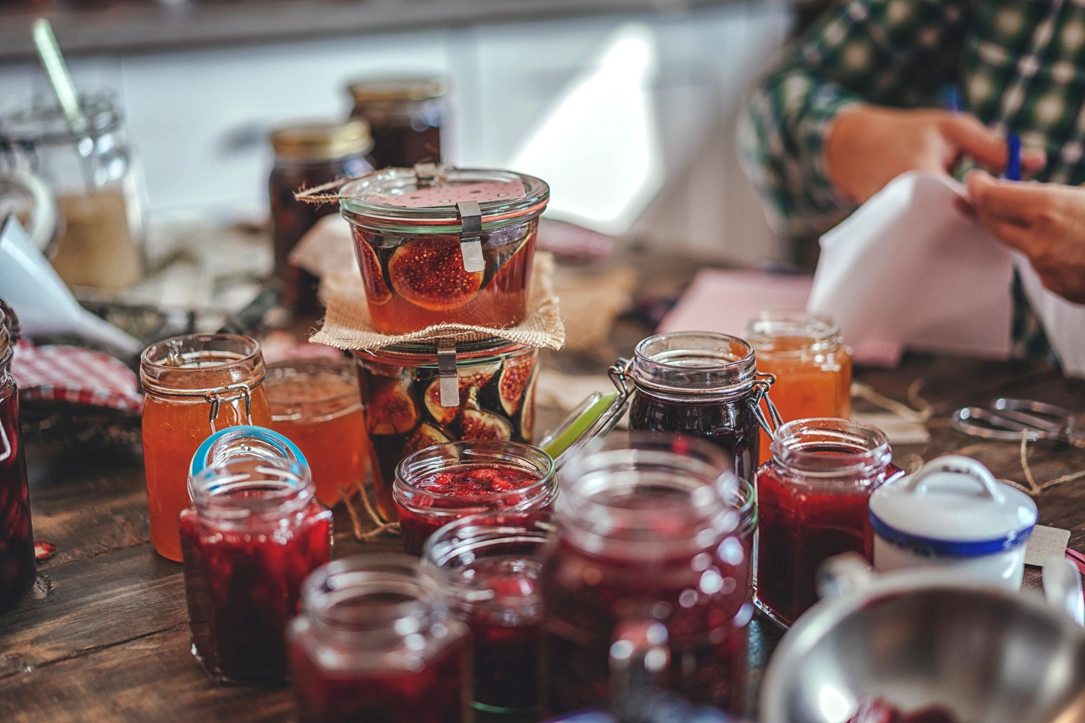 homemade strawberry jam in jar on kitchen counter